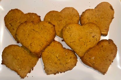 Heart shape apple natural dog treats on a white plate