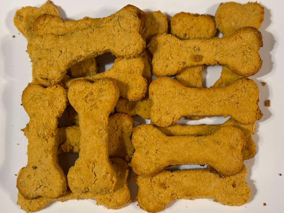 bone shaped sweet potato natural dog treats on a white plate