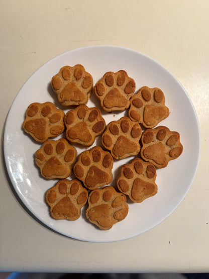 Paw shape sweet potato natural dog treats on a white plate