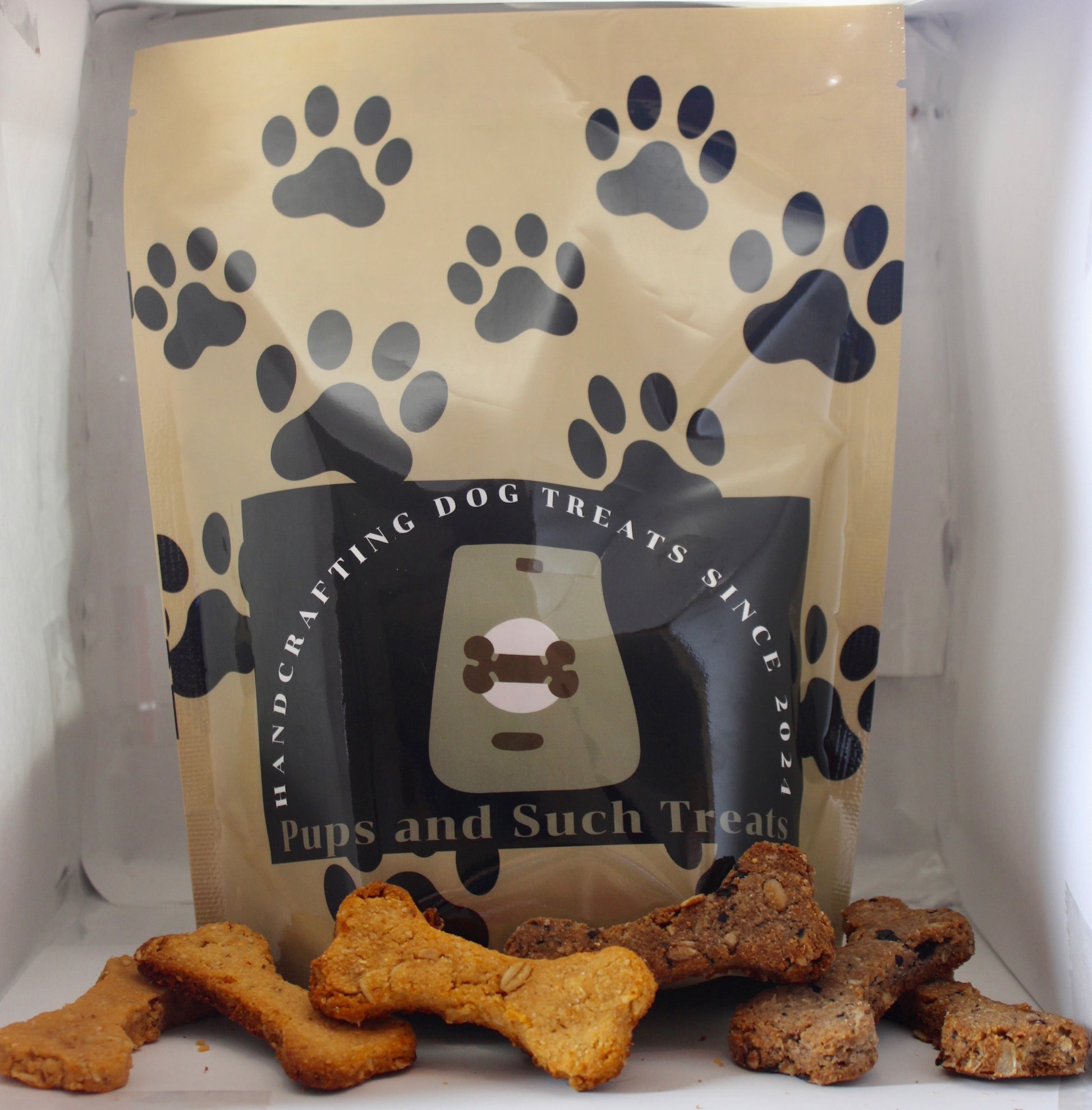 Dog treat packaging with black paw prints on a white background