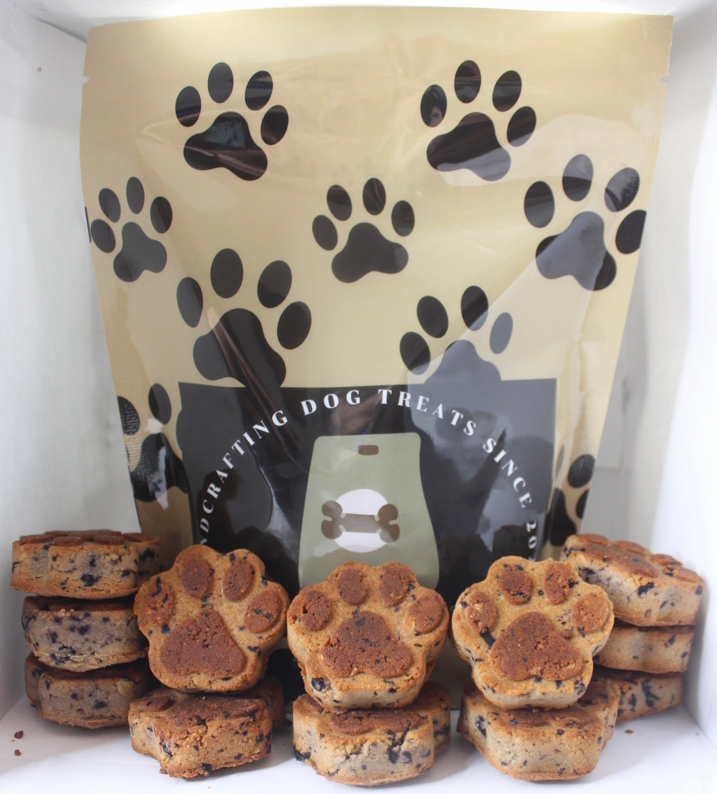 Dog treat packaging with black paw prints on a white background