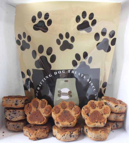Dog treat packaging with black paw prints on a white background