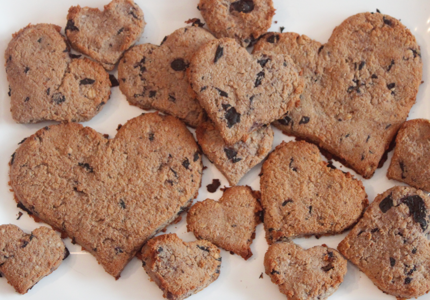 Heart shape blueberry natural dog treats on a white plate