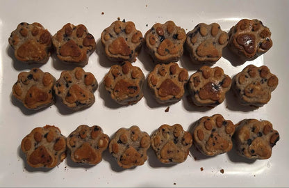 Paw shape blueberry natural dog treats on a white plate