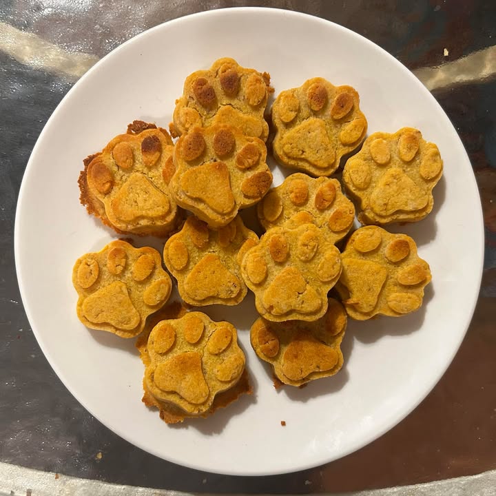 Paw shape sweet potato natural dog treats on a white plate