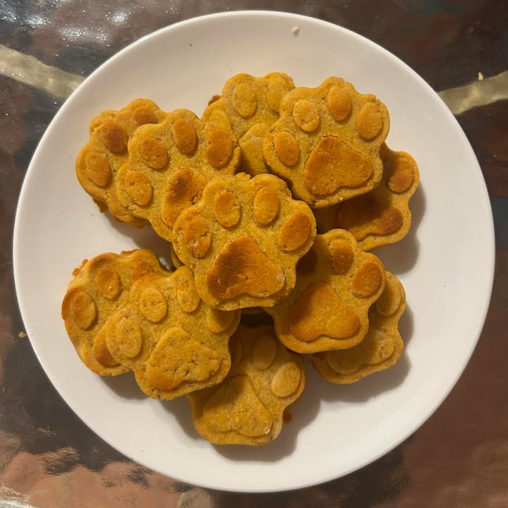 Paw shape sweet potato natural dog treats on a white plate