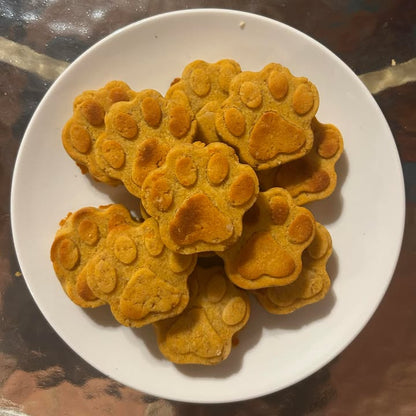 Paw shape sweet potato natural dog treats on a white plate